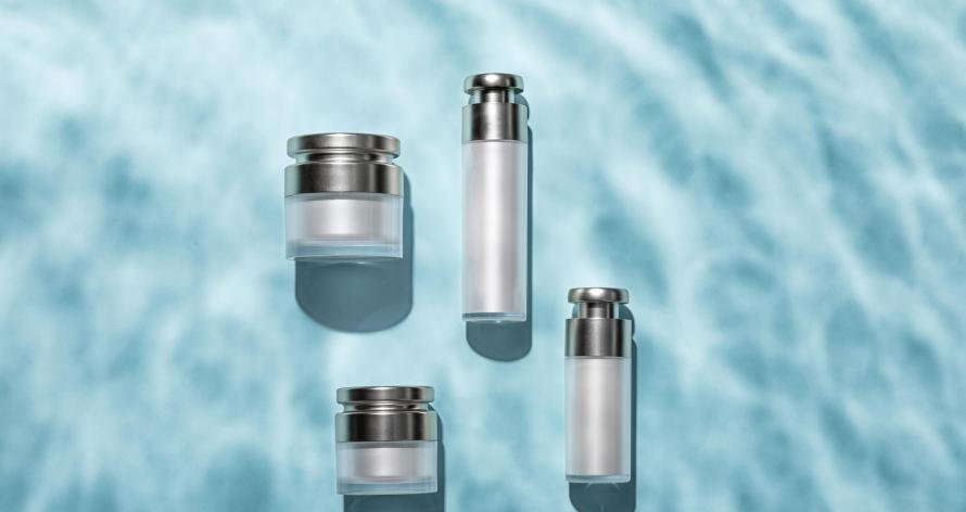 Top view of skincare bottles on a light blue water surface A top view of skincare bottles on a light blue water surface